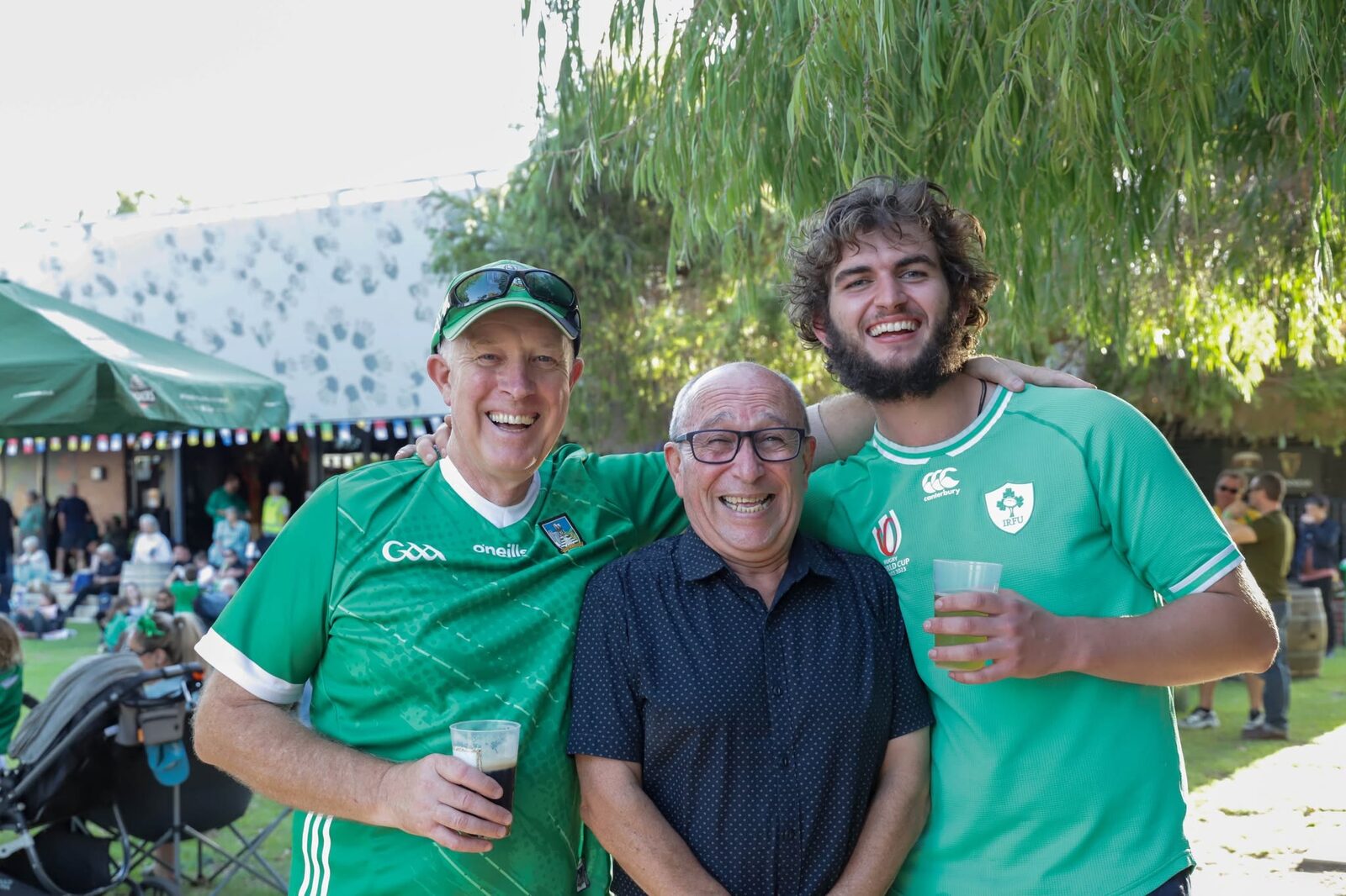 Three of us in Irish county jerseys at the festival, under the trees
