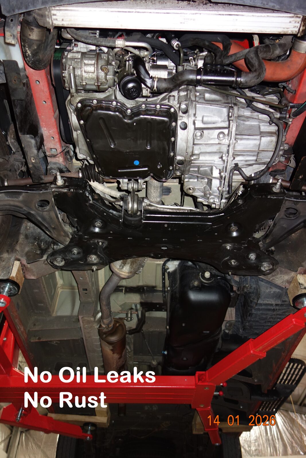 The underside of the van photographed on a hoist